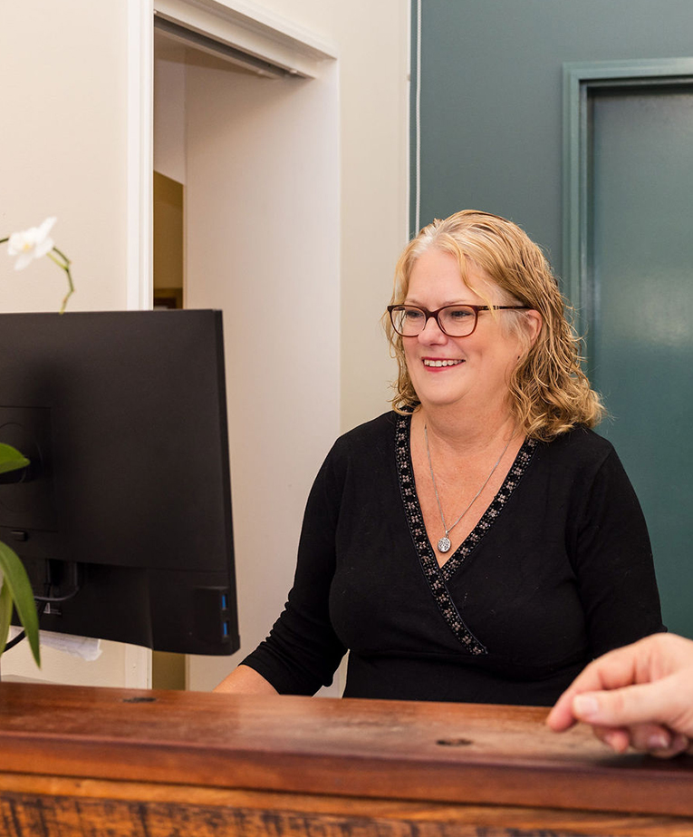 A Junction Street Family Practice Receptionist welcoming a patient